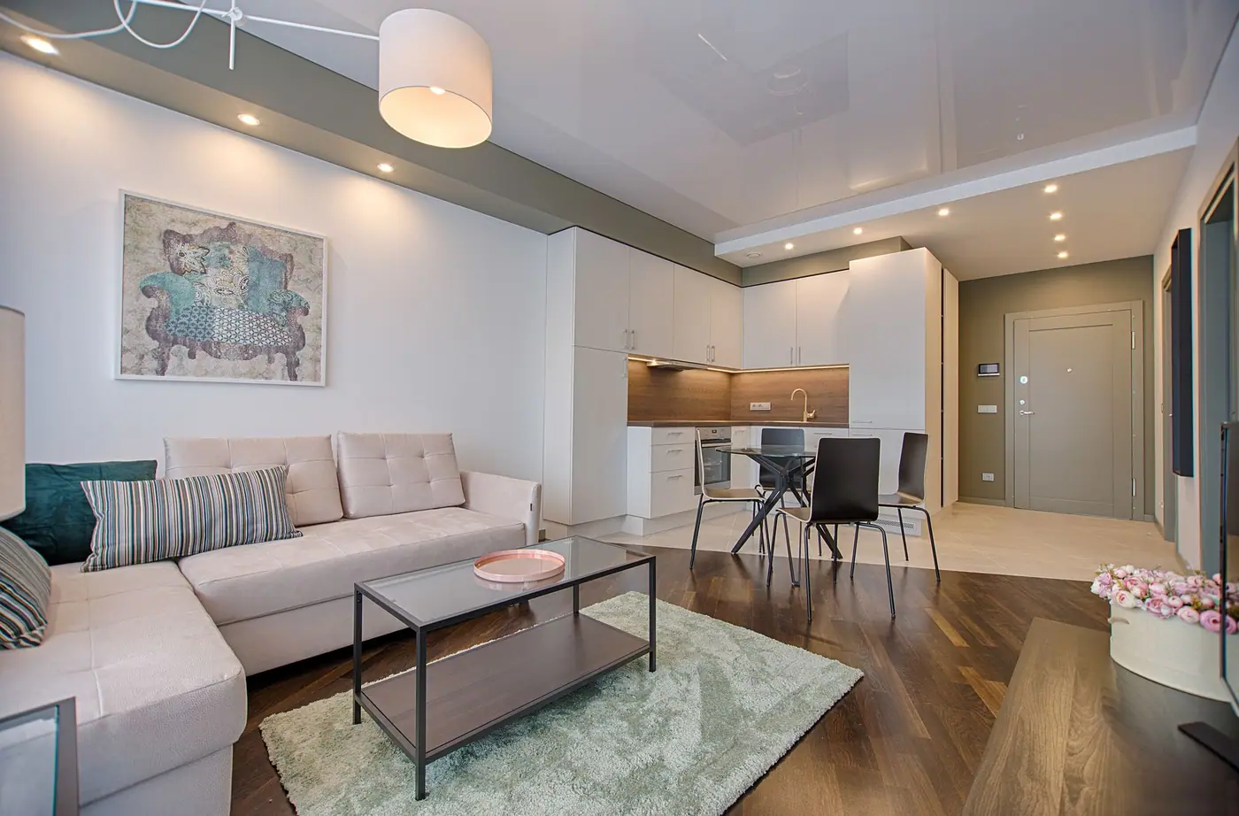 Compact living space with sofa, dining chairs, and a kitchen run